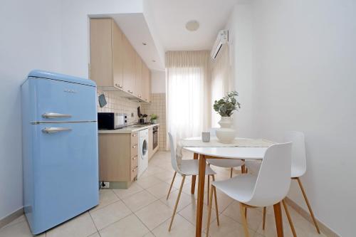 a kitchen with a blue refrigerator and a table at Centro storico - Ottimo Collegamento aeroportuale e Roma in Fiumicino