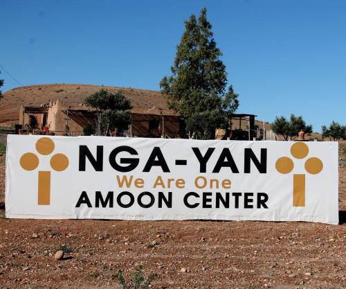 a sign that says naa yarn we are one arrow center at Ngayan Camp in Marrakech