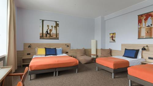 a room with two beds in a room at Corner Hotel in Vilnius