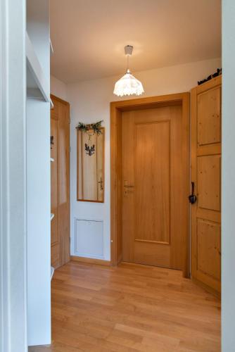 a room with a wooden door and a hallway at Chesa Quadratscha - Samedan in Samedan