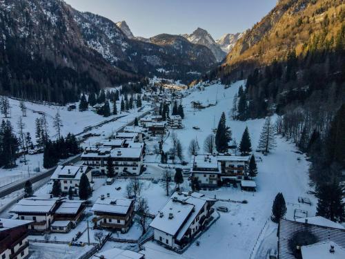 a village in the mountains covered in snow at Chalet Kalipe in Rocca Pietore