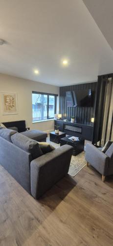 a large living room with couches and a large window at Sleek modern design - 2 bed apartment in Donegal Town in Donegal