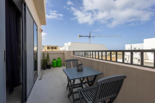 a patio with a table and chairs on a balcony at Penthouse Near Paceville with Private Terrace by QuickTrips in Is-Swieqi