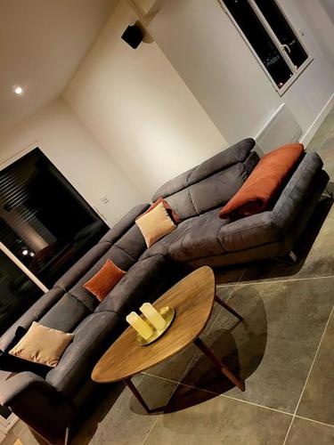 a living room with a couch and a coffee table at NALAN Godvicien, Spa, piscine chauffée, forêt, 14 pers in Gouvieux