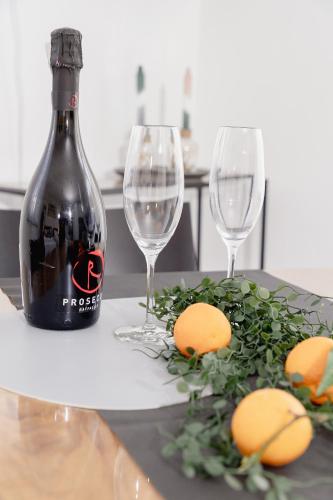 a bottle of wine and two wine glasses on a table at GrenzApartments in Bietingen