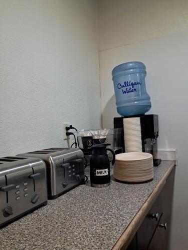 a kitchen counter with a stove and a blender at Motel 6-Regina, SK in Regina