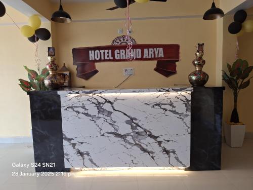 a sign for a hotel guest army on a marble counter at Hotel Grand Arya in Hilsa