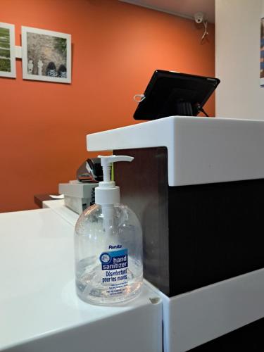 a bottle of detergent sitting on top of a machine at Motel 6-Regina, SK in Regina