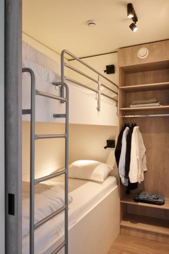 a bedroom with a bunk bed and a closet at Holiday Suites Zeebrugge in Zeebrugge