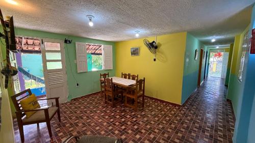a dining room with a table and chairs at Casa Bantu - Vila Rosa in Vera Cruz de Itaparica
