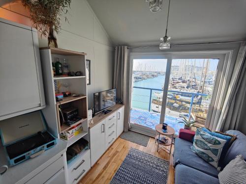 a living room with a large window with a view at The Boat View - Sea View - Tiny home Brighton Marina in Brighton & Hove