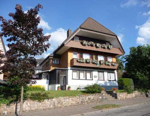 a house with flower boxes on the side of it at Ferienwohnung Dachtler in Hinterzarten