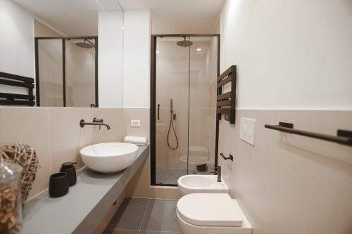 a bathroom with a toilet and a sink and a shower at Bargello Nine Luxury Suite in Florence