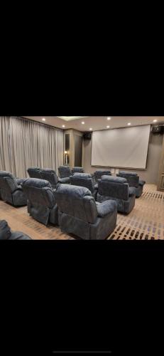 a large room with couches and a projection screen at Skytrees 公寓 距Aeon五分钟路程 in Johor Bahru