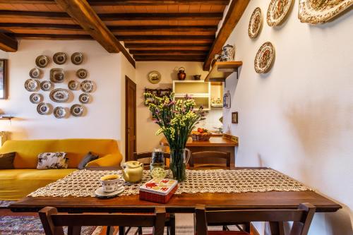 a living room with a table and a couch at Top of hill, with view on Siena, Chianti and Crete in Montaperti