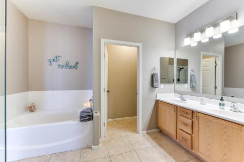 a bathroom with a tub and a sink at Pool, Patio and Grill San Tan Valley Escape! in Queen Creek