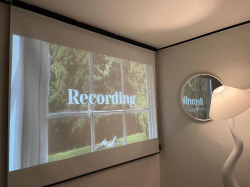 a room with a window with a round mirror and the word recording at Naroo Stay - DDP and Jong-ro in Seoul