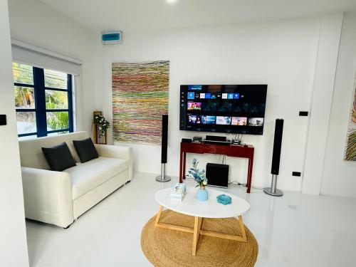 a living room with a couch and a table at Bophut Fisherman's Village Blue Ocean Villa in Bophut