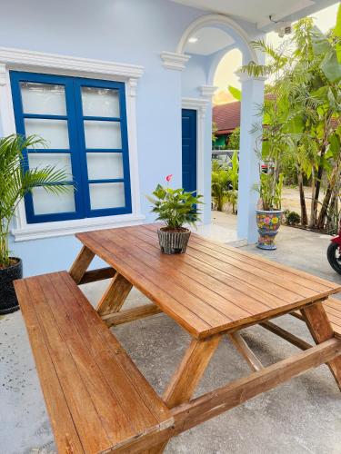 a wooden picnic table in front of a house at Bophut Fisherman's Village Blue Ocean Villa in Bophut