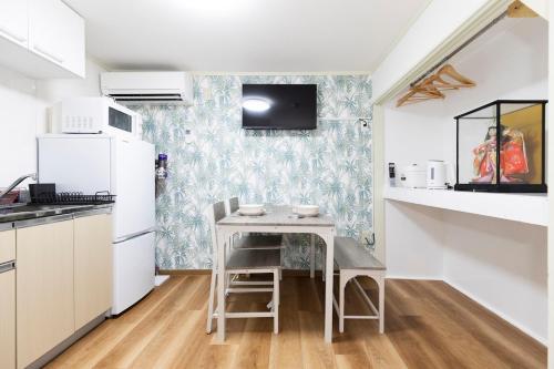 a small kitchen with a small table in a room at Forest Guest House Shinjuku city center in Tokyo