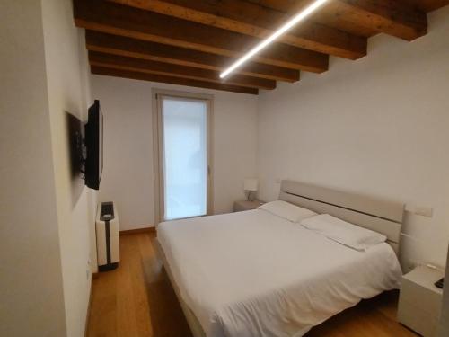a bedroom with a white bed and a window at Residenza Della Samaritana in Verona