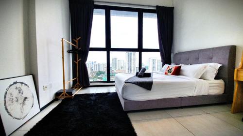a bedroom with a bed and a large window at Near Georgetown with Beautiful city view 2 room fit 4 to 7 pax in Jelutong