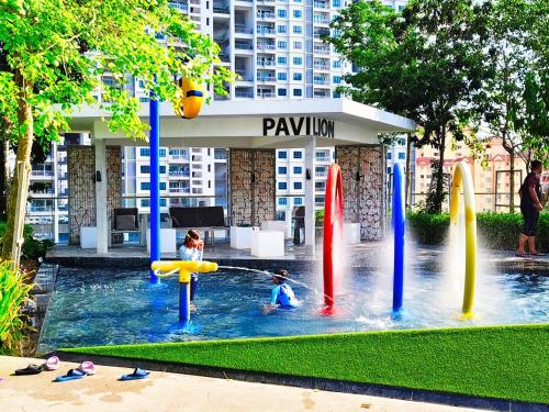 two children playing in a water park with surfboards at Near Georgetown with Beautiful city view 2 room fit 4 to 7 pax in Jelutong