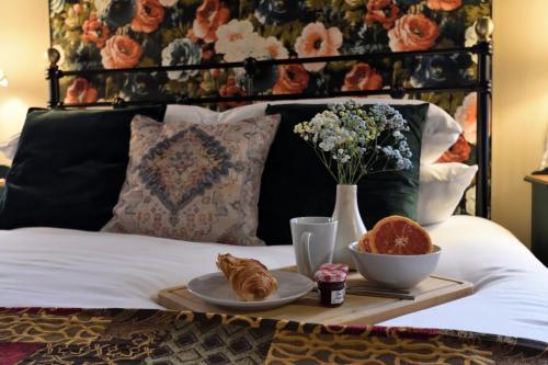 a tray with croissants and a plate of food on a bed at Samuels' a duplex apartment by Spires Accommodation in Lichfield City Centre in Lichfield