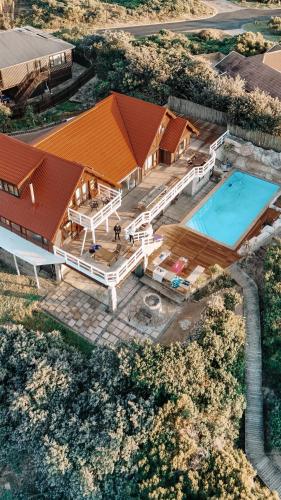 an overhead view of a house with a swimming pool at Surf Lodge South Africa in Jeffreys Bay