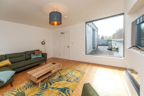 a living room with a couch and a table at Modern Luxury -Four Bed House in Galway