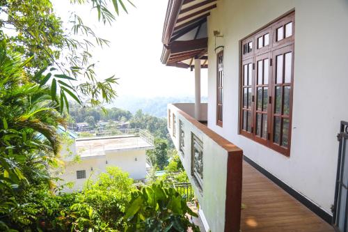 a balcony of a house with a view at Mountain Bliss Villa Peradeniya in Peradeniya