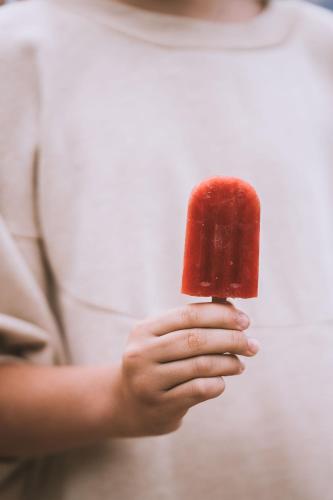 a person holding a red object in their hands at Garberhof Dolomit Family in Rasùn di Sotto