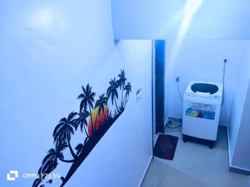 a bathroom with a palm tree mural on the wall at ColvaPearl Deluxe Luxury Villa and Apartments Wi-Fi in Colva