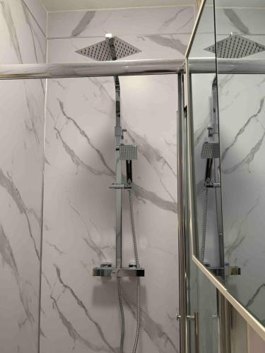 a shower with two lights in a bathroom at Beautiful Double Ensuite Room in Erith