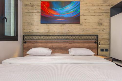Una cama o camas en una habitación de Amine Apart-Hotel by Stayinn