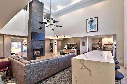 a living room with a couch and a fireplace at Staybridge Suites - Albuquerque Airport by IHG in Albuquerque