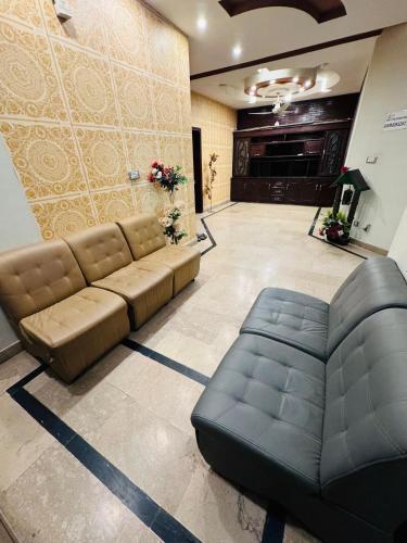 a living room with a couch and a fireplace at MadCrew Guest House in Islamabad