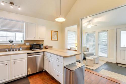 a kitchen with white cabinets and a sink at Cozy Home with Yard about 9 Mi to Dtwn Charleston! in Charleston