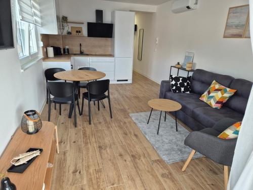 a living room with a couch and a table at Sunshine Apartment Complex with a Pool by the Beach - Mandre, Pag in Mandre