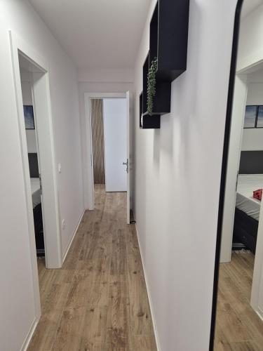 a hallway with white walls and a hard wood floor at Sunshine Apartment Complex with a Pool by the Beach - Mandre, Pag in Mandre