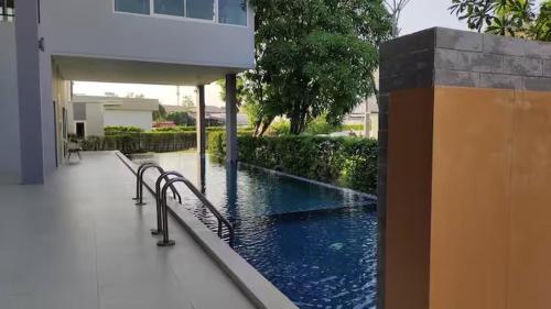 a swimming pool in the middle of a building at The Cozy Place 105 Private 3 beds 3 baths Lasalle Bangkok in Bangna