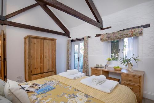 Ένα ή περισσότερα κρεβάτια σε δωμάτιο στο Rose Cottage