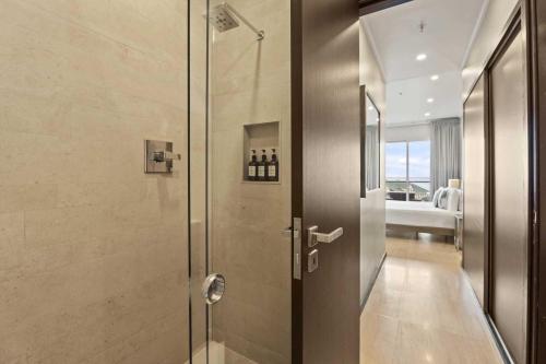 a shower with a glass door in a bathroom at Beach View - Beach Royale 2BR condo - LV406 in Palm-Eagle Beach