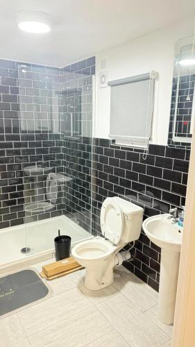 a bathroom with a toilet and a sink at Elliotts Cabin in Grange