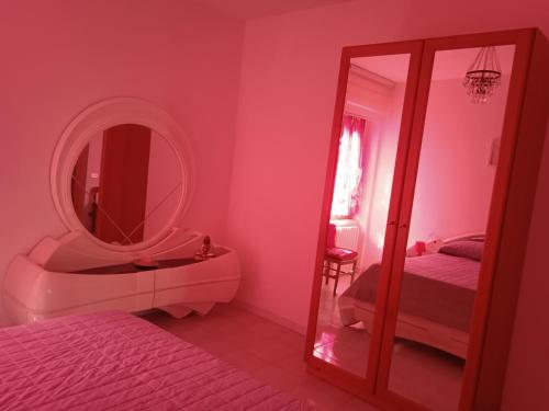a bathroom with a mirror and a sink and a bed at La casa di Alex in Rionero in Vulture