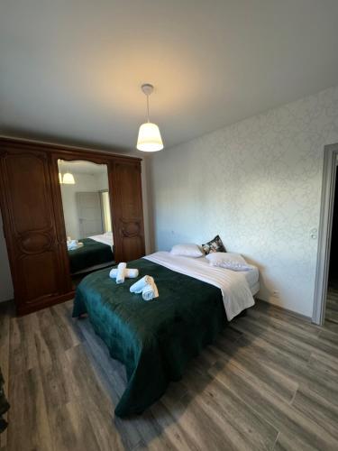 a bedroom with a bed with two towels on it at Villa Entière in Montauban