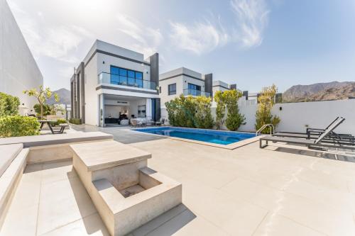 an image of a villa with a swimming pool at Overlooking Pool & Sea Views Villa with BBQ Facility, Sharm - Al Dana Villa, Al Dana Island by Deluxe Holiday Homes in Fujairah