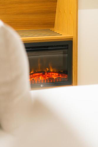 a fire in a fireplace in a room at Quinta Casal da Silva 1951 in Magrelos