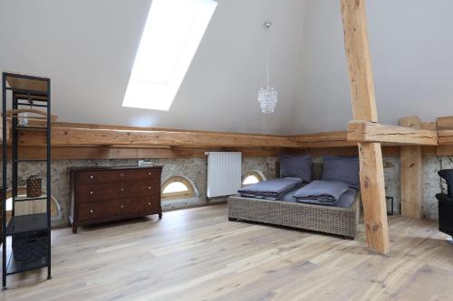 a bedroom with a bunk bed and a wooden floor at Burg 2 - Ferienwohnungen in Taching am See