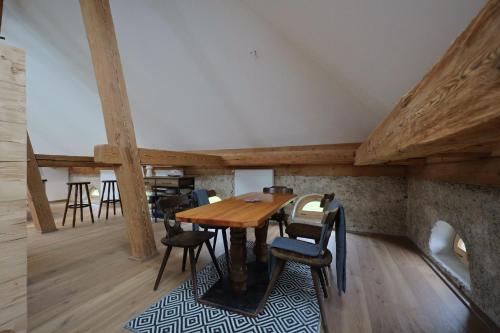 a dining room with a wooden table and chairs at Burg 2 - Ferienwohnungen in Taching am See
